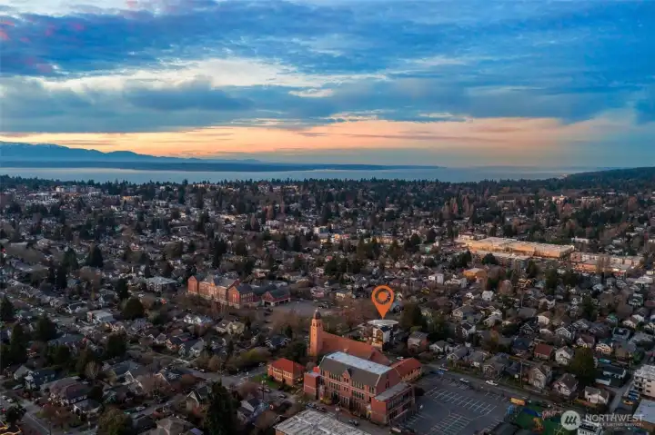 Aerial view highlighting the home's proximity to Green Lake and breathtaking panoramic vistas of the Olympic Mountains and Puget Sound.