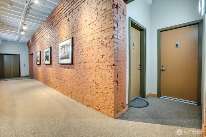 Located on the third floor, the approach to your front door is framed by soaring ceilings, exposed old-growth beams, and aged brick—an instant infusion of urban character.