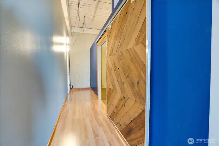 A striking sliding barn door creates separation and privacy between the bedroom and entry while adding distinctive loft style.