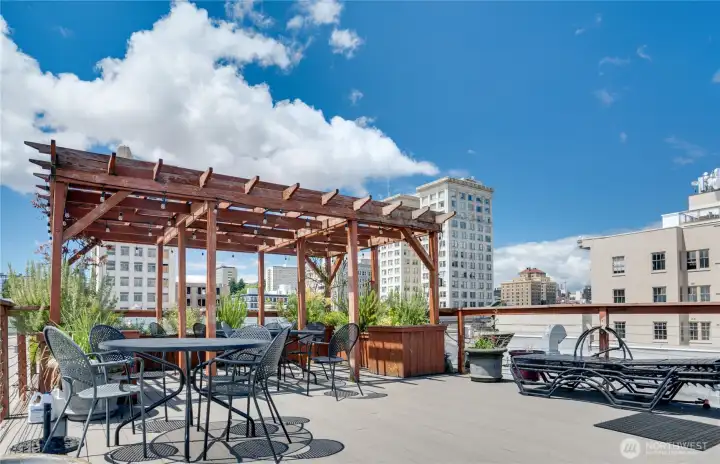 Imagine hosting friends on the rooftop deck, complete with a shaded pergola, BBQ grill, and breathtaking 360-degree views—perfect for sunset gatherings.