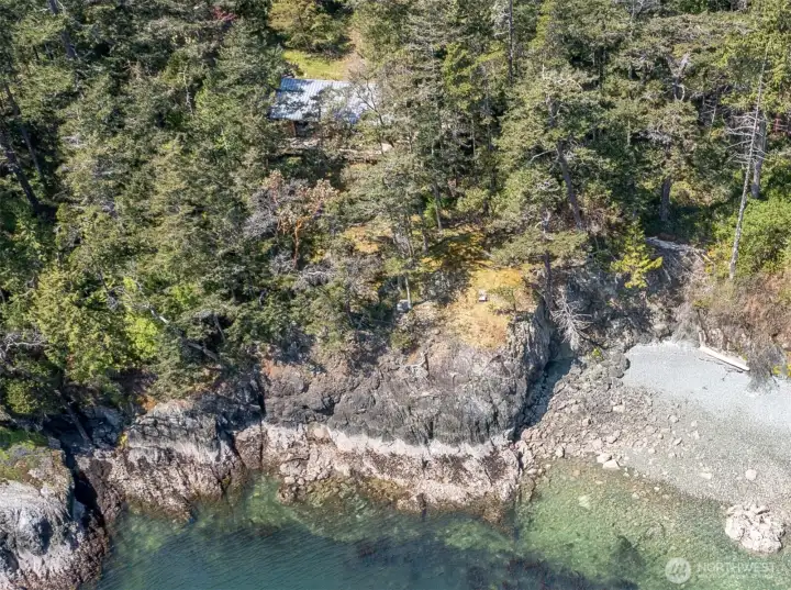 At the bottom left of this photo is the rocky cove where owner launches his paddleboard. He says this is easier access than stairs would be at the common beach parcel shown on the right side of the photo.