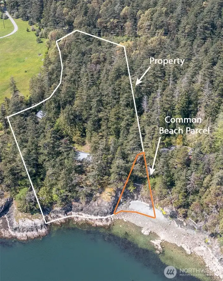 Aerial which shows positioning of the garage and the house and approximate property lines. The common beach parcel is co-owned with neighbor to the south (left side of this photo) but beach access hasn't been developed as there is natural access via the rocky cove. Both the property and beach parcel include ownership of 2nd class tidelands.