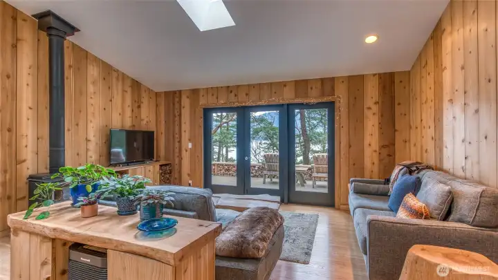 The rustic console behind the couch and the wood storage cabinet under the TV were built by owner. Furnishings are available.