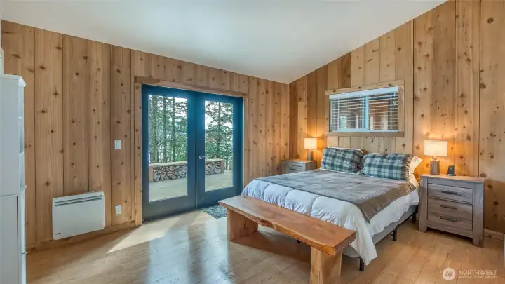 New wide plank cedar paneling in the bedroom adds a cozy feel. Just out the door is the hottub, and the bathhouse, visible through the window, is just around the corner. new blinds.