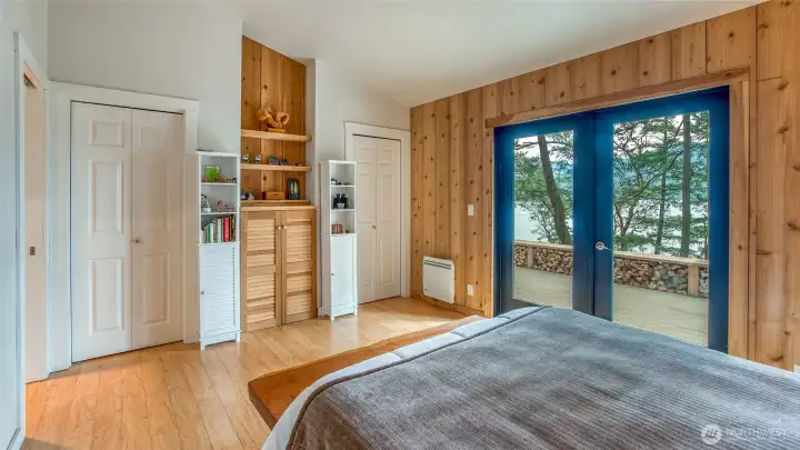 Two closets in main bedroom. Owner added the wood built-in in the center.