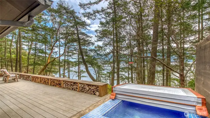 Tiled hottub with a wooded backdrop for privacy