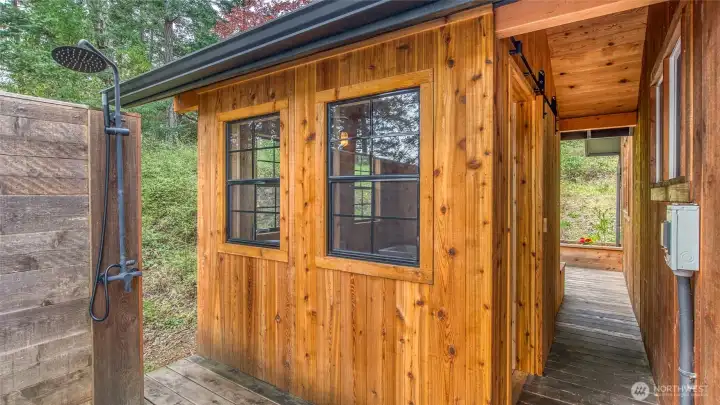 New outdoor shower (cold only) next to the hottub. The new cedar bathhouse is access via a rustic barn door.