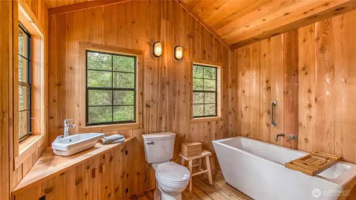 Pinterest-worthy bathhouse wrapped in aromatic cedar. Bathhouse is quickly heated by a wall heater, not shown.