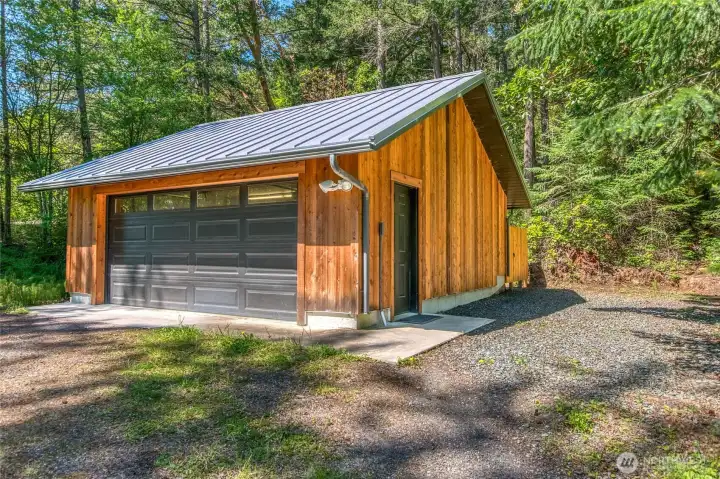 Like the house, the garage has metal roofing and new 1" thick cedar siding. Additional parking on side.