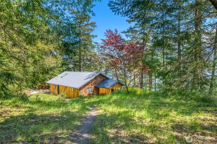 By approaching to the home via a rustic path, you begin to relax surrounded by nature