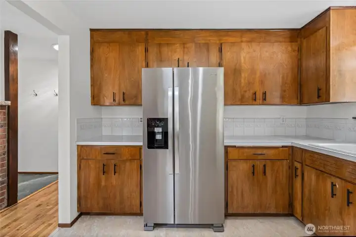Side-by-side stainless steel refrigerator stays with the home.