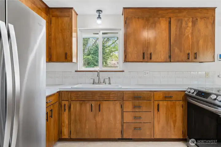 Window over the kitchen sinks with a view to your fully fenced backyard.