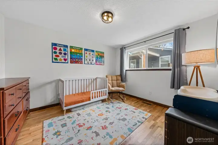 The wood flooring continues into bedroom 3.