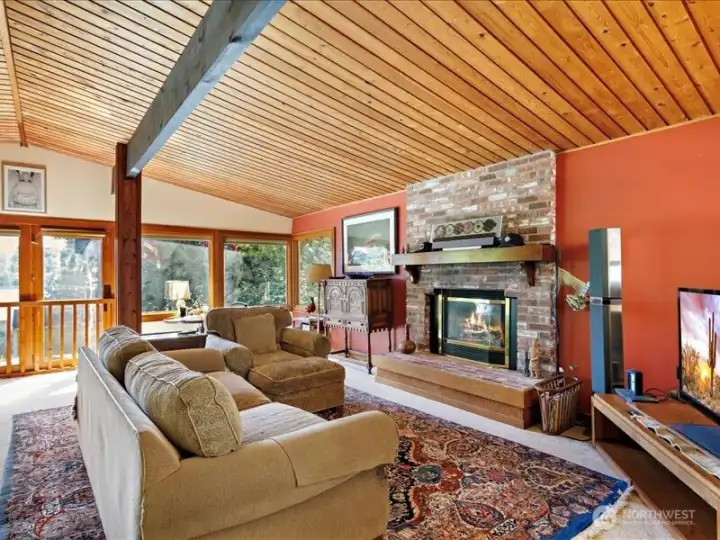 The Living room is accented with fireplace and high ceilings.