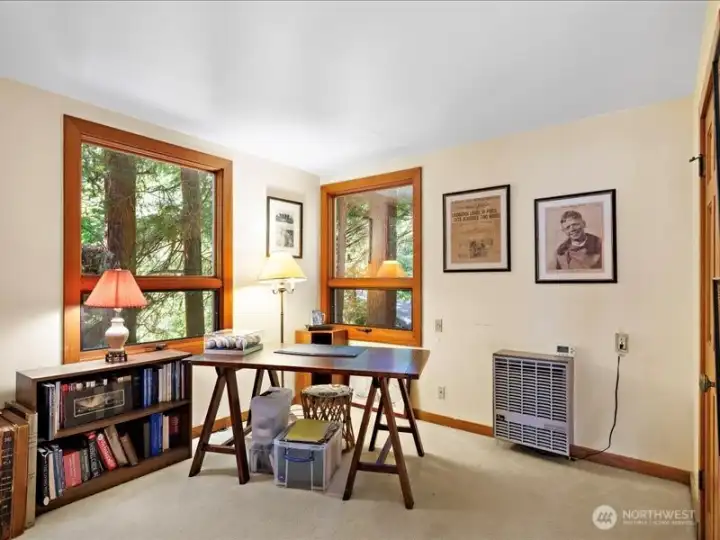 Main level bedroom with 1/2 bath used as an office.