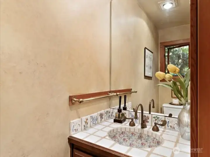 Charming half bathroom for the main level room.