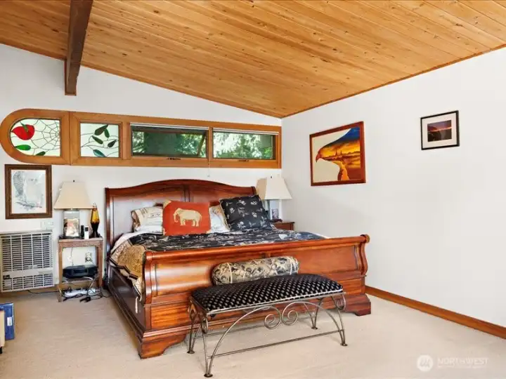 Primary bedroom with wall of windows.