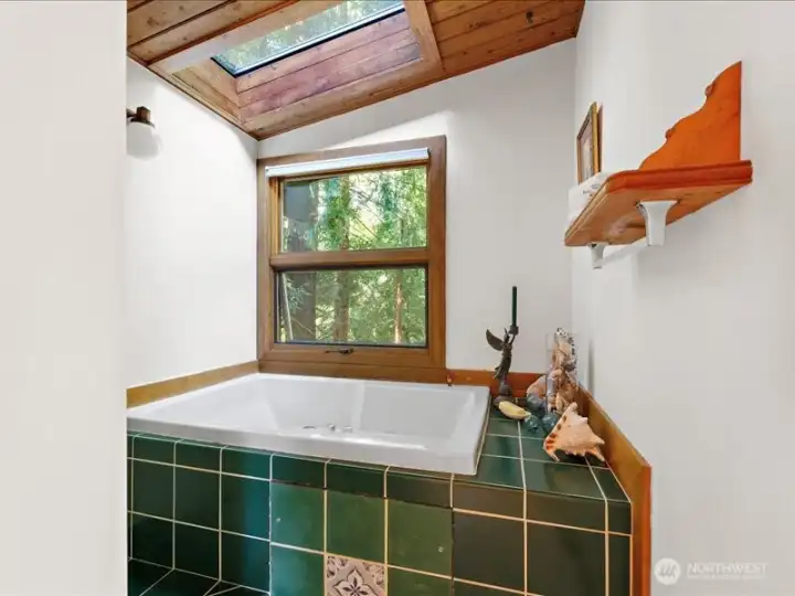 Soaking tub and shower around the corner.