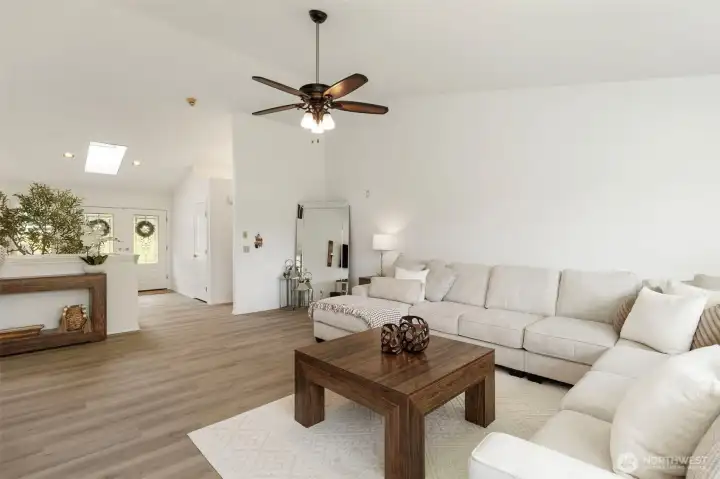 Natural light pours through the skylight, enhancing the airy feel of this refined main living space. Soft tones, elegant finishes, and an open flow create a bright, welcoming setting for elevated Port Orchard living.