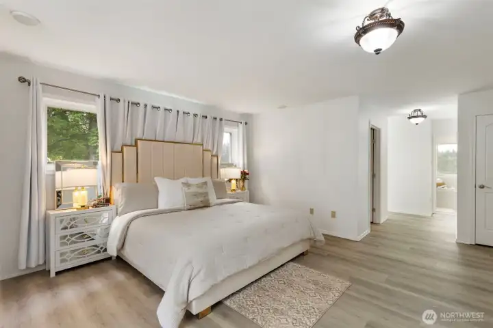 Gorgeous and spacious main-level primary bedroom with soft natural light, elegant finishes, and serene views—designed as a refined private retreat for luxury everyday living.