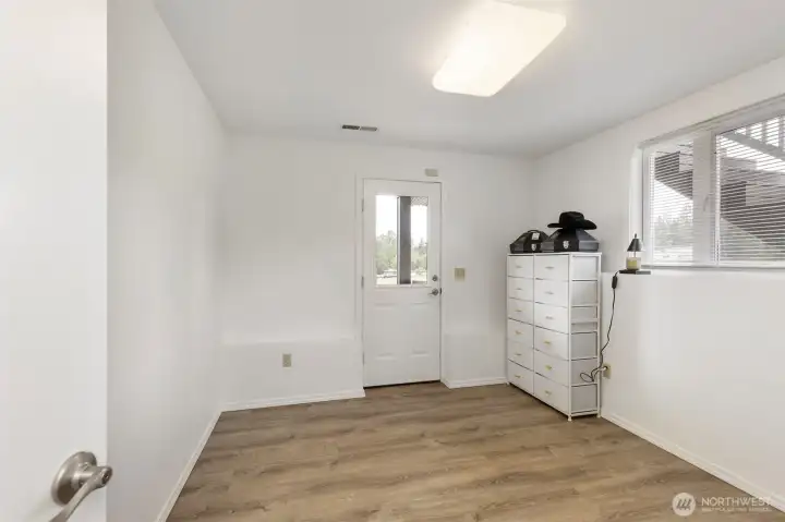 Flexible downstairs room with exterior access, natural light, and clean finishes—ideal for a home office, guest room, hobby space, or private retreat.