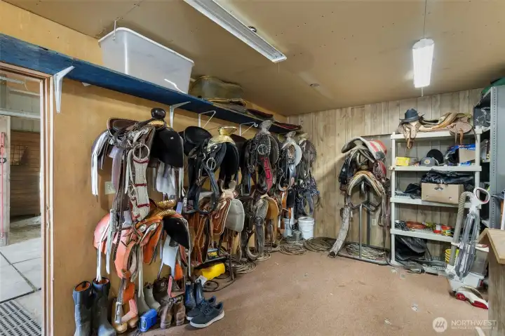 Dedicated tack room with organized saddle storage, gear space, and a washer—adding convenience, function, and everyday efficiency to the barn setup.
