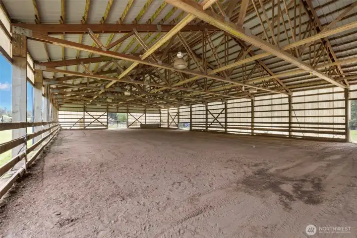 Spacious covered arena with lighting, offering a year-round riding destination for training, exercise, and versatile equestrian use.
