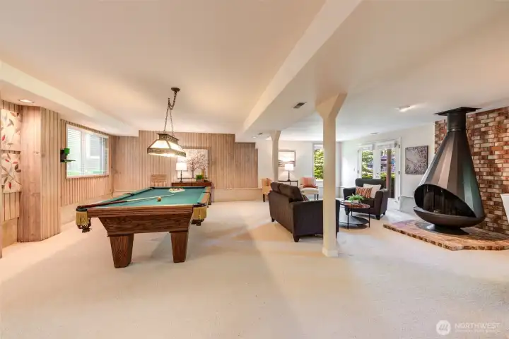 Sprawling lower-level living space with room to relax, entertain, or gather around the pool table- included with the home.