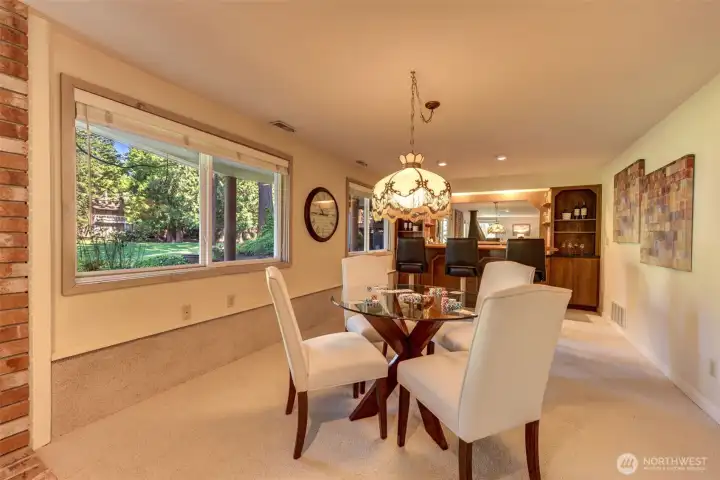 Flexible lower-level entertaining space great for game nights, with backyard views, built-in bar area, and a statement chandelier- included with the home.