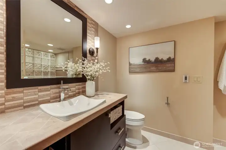 Updated lower-level bathroom with updated finishes, vessel sink vanity, and warm touches throughout.