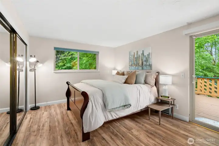 Downstairs primary has direct access to the rear deck, and its own half-bath.