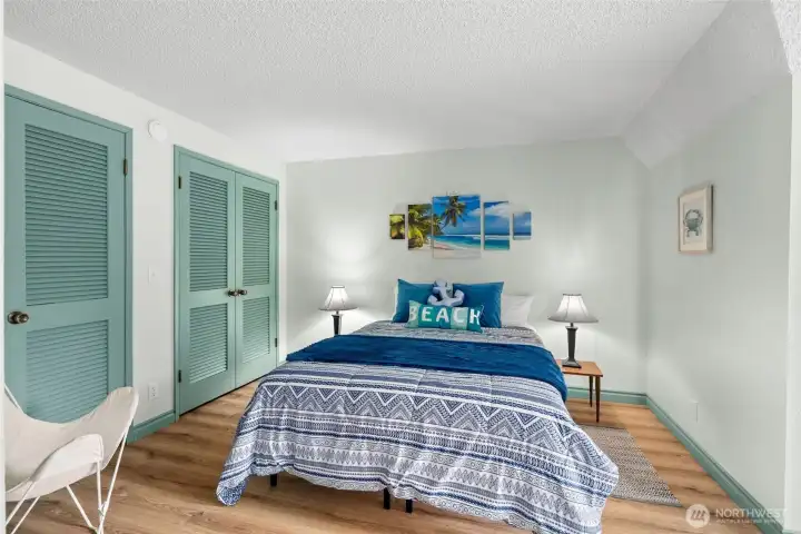 Upstairs guest room is bright, with a window seat and plenty of closet space