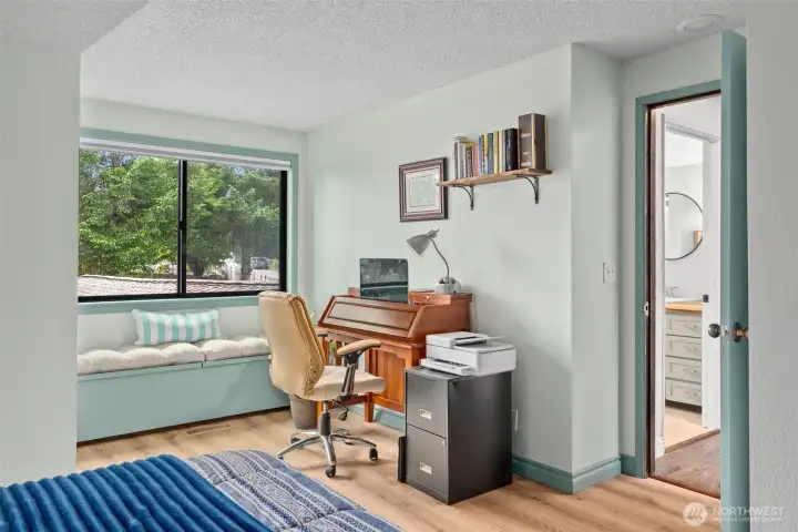 Upstairs guest room is bright, with a window seat and plenty of closet space