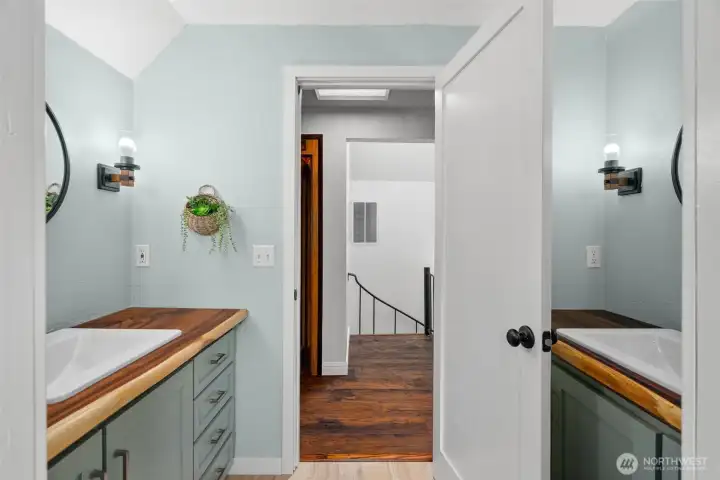Upstairs bath features facing vanities, each with custom crafted wood counters and updated styling