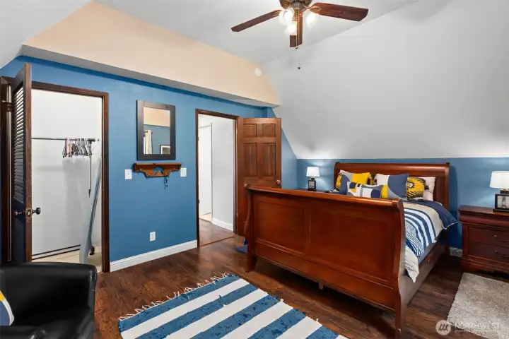 Upstairs primary with vaulted ceiling and large closet, plus balcony