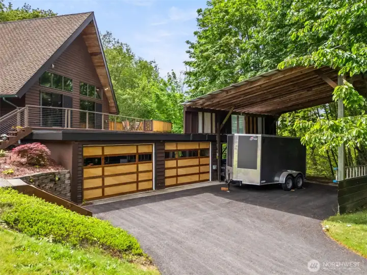New custom crafted garage doors in beautiful wood shades, plus covered parking for your trailer, boat and/or RV.  30 and 50-amp hookups too.