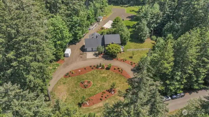 The circle drive accents the wonderful landscaping