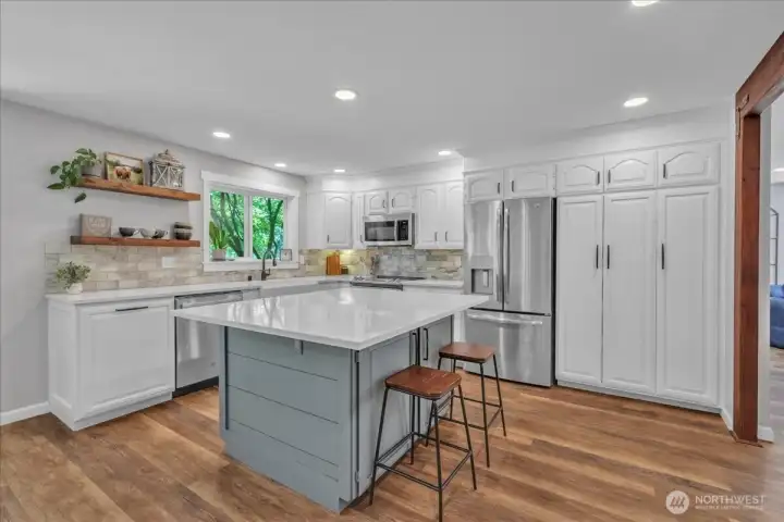 With quartz counters, white cabinets, stainless steel appliances and built in pantry space this kitchen has all you need!