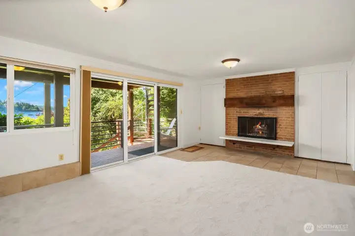Primary suite with fireplace and access to lower deck.