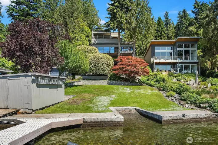 Beautiful lawn with a rare boathouse at waters edge.