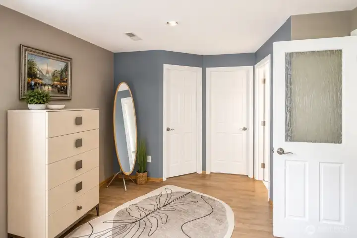 Primary bedroom dressing nook includes two walk -n closets.