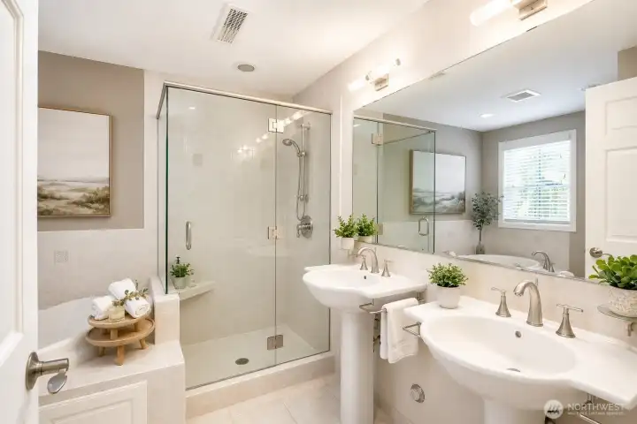 Spa-inspired primary bath featuring a luxurious walk-in shower enclosed by premium heavy glass doors.