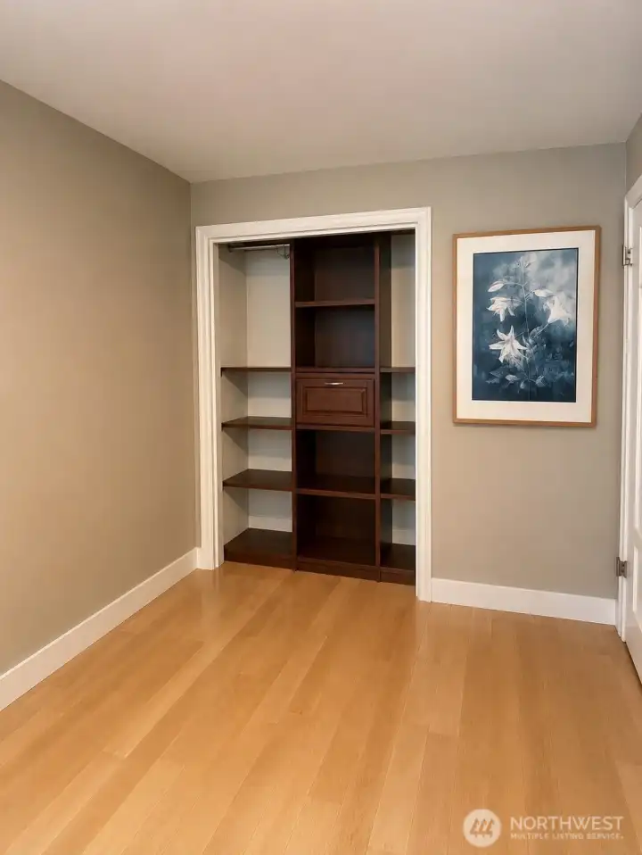 main level den with custom closet organizer.