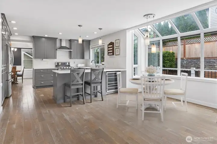 Virtually staged breakfast nook and sparkling kitchen