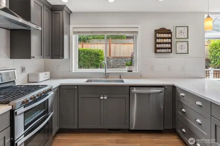 Quartz countertops and a gas range