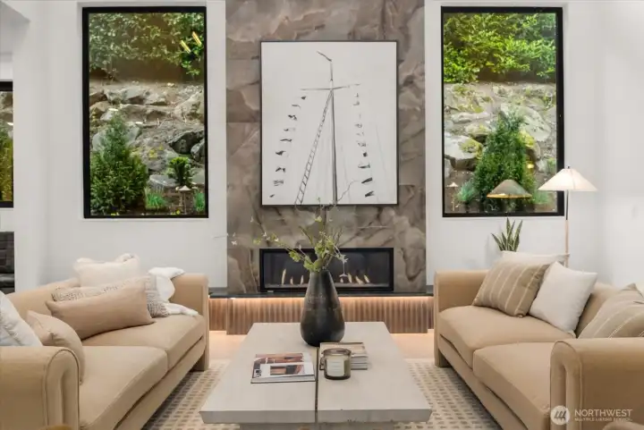 Gas fireplace, engineered hardwood floors, Brazilian quartzite slabs, and panoramic slide doors. Gas fireplace, engineered hardwood floors, Brazilian quartzite slabs, and panoramic slide doors.