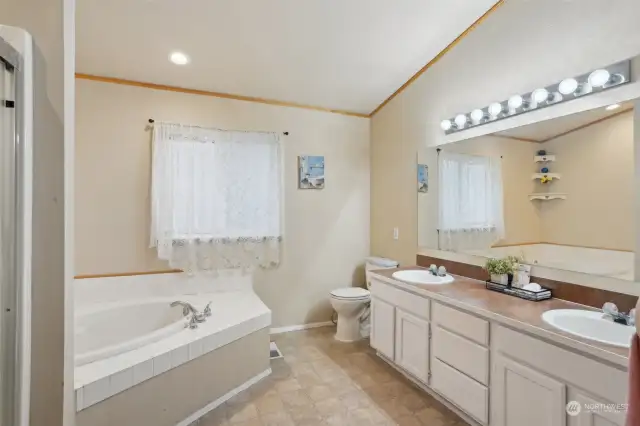 Spacious 5-pc primary bath suite with dual closets makes a great private retreat.