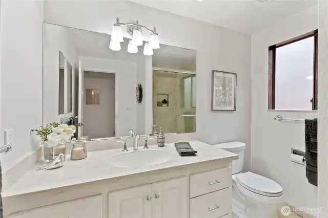 The ensuite primary bathroom has an oversized shower and plenty of room to get ready in the morning.