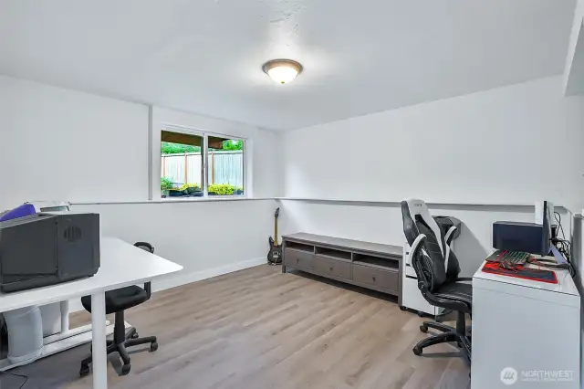 Bright fourth bedroom with large window overlooking the backyard. Perfect for a home office, studio, or hobby area.