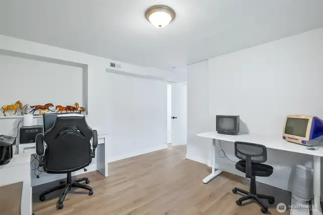 Versatile lower-level flex space with built-in desks and updated flooring. Ideal for office, gaming, another bedroom or creative use.